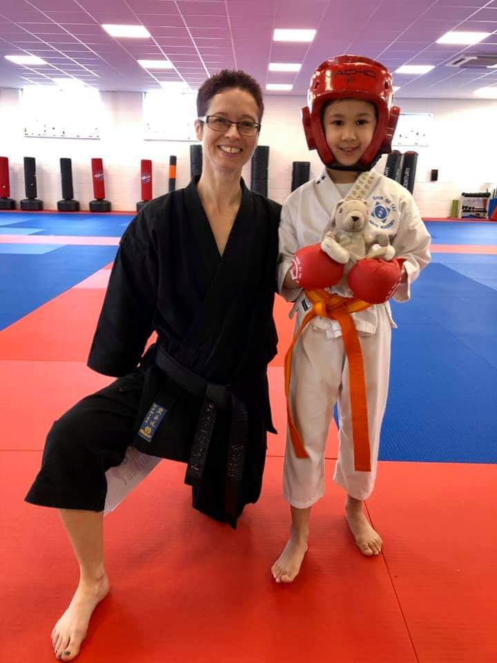 Photo of martial arts coach and child