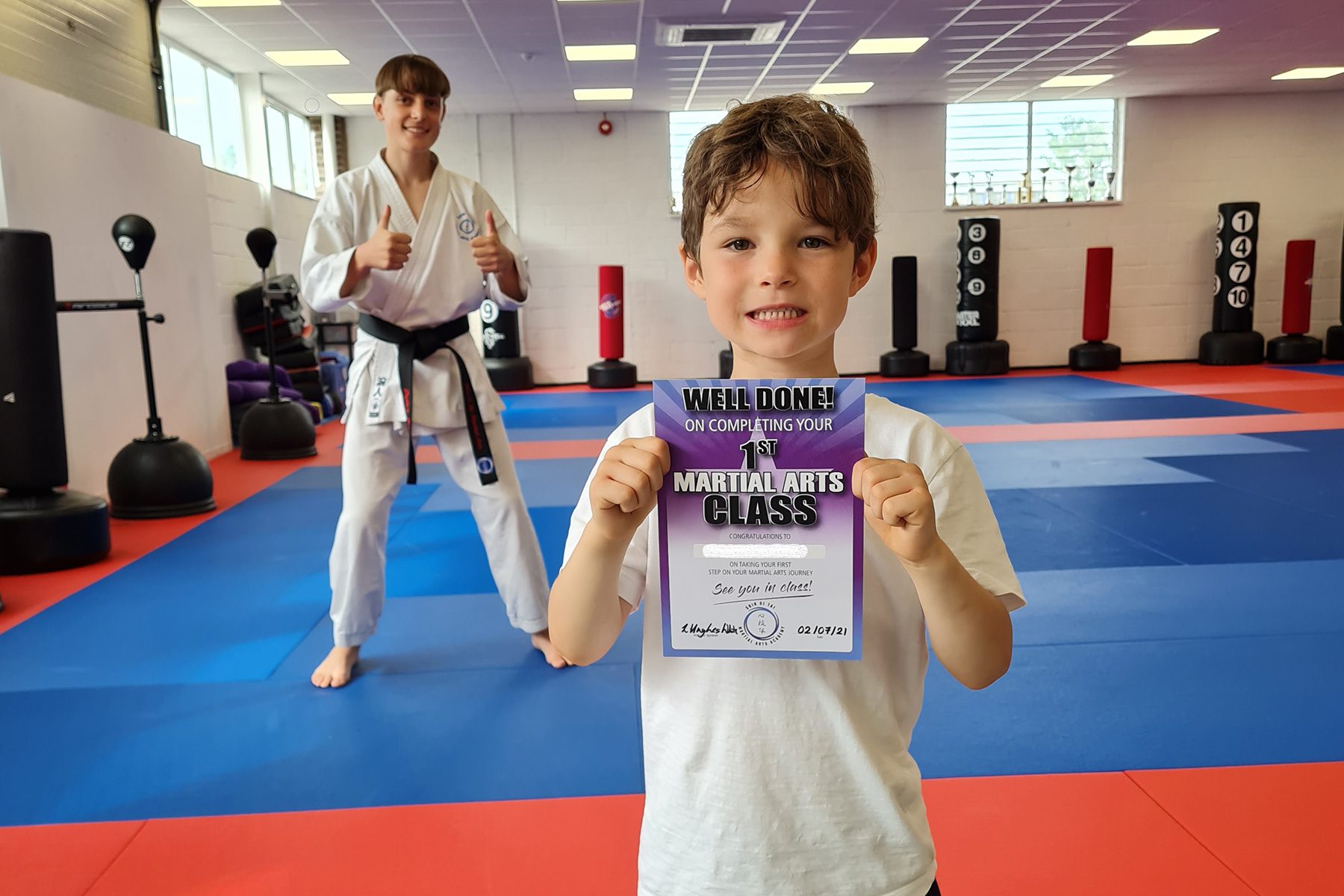 Image of child with award for completing his taster class