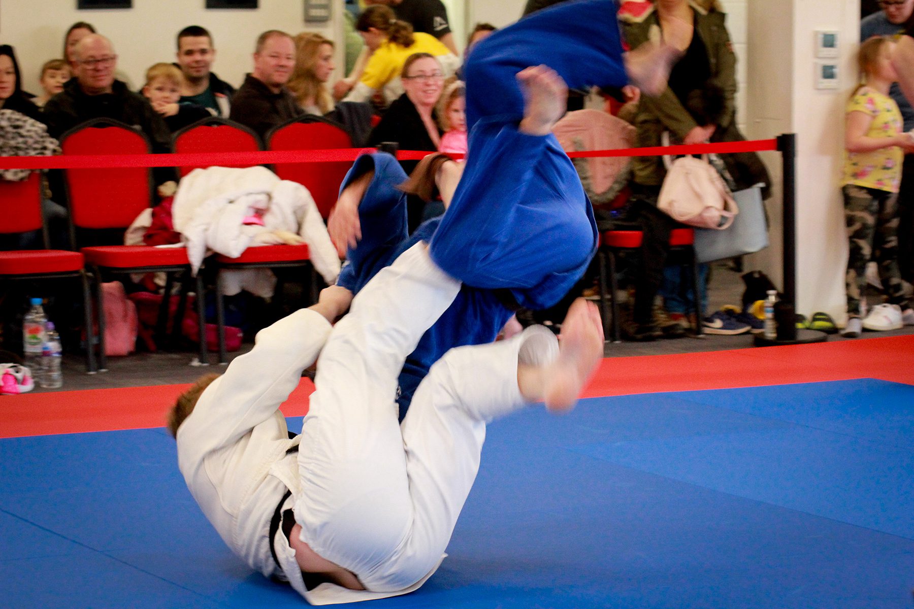 Photo of adults judo class with spectators